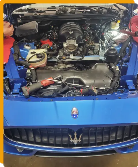 Vehicles We Service In Tomball TX At Jon’s Auto & Diesel Repair. A blue Maserati with its hood open reveals the engine and various tools placed inside, indicating ongoing maintenance or repair work.