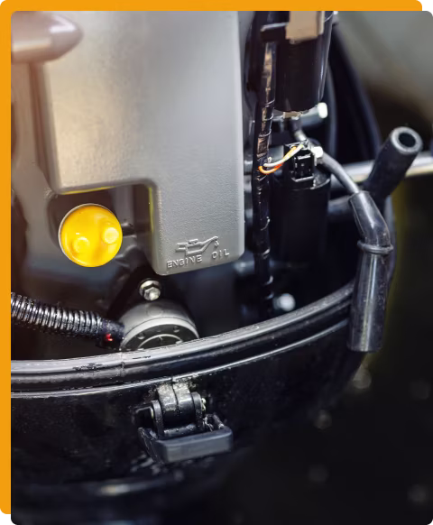 Boat and watercraft repair and maintenance in Tomball, TX. at Jon's Auto & Diesel Repair shop. Closeup image of mechanic using a wrench on a boat engine to perform maintenance on it.